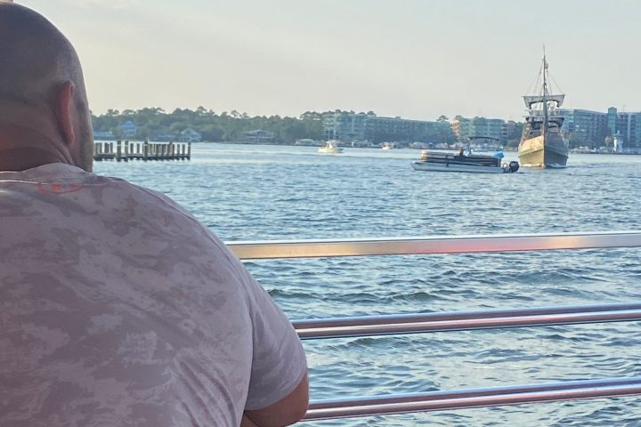 a man sitting in front of a body of water